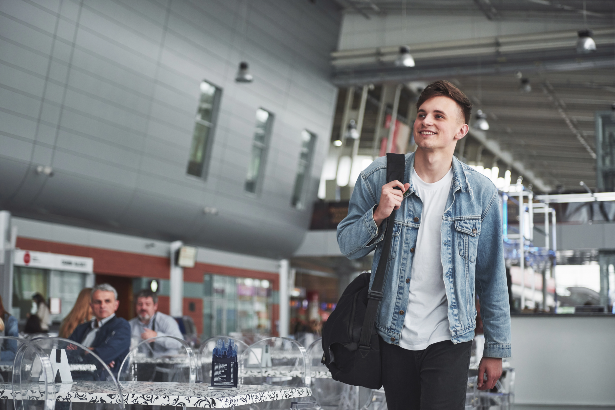 young-handsome-man-with-bag-his-shoulder-hurry-airport